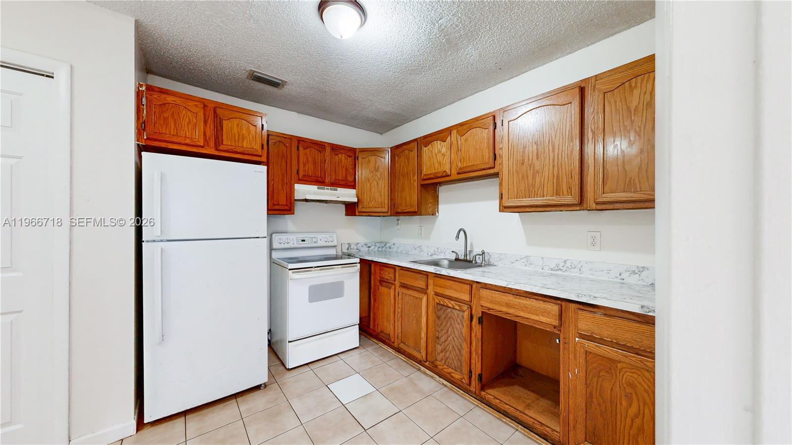 1664 Southwest 2 Court Homestead, FL 33030 - Photo 7 of 57 a kitchen with stainless steel appliances granite countertop a refrigerator sink and cabinets