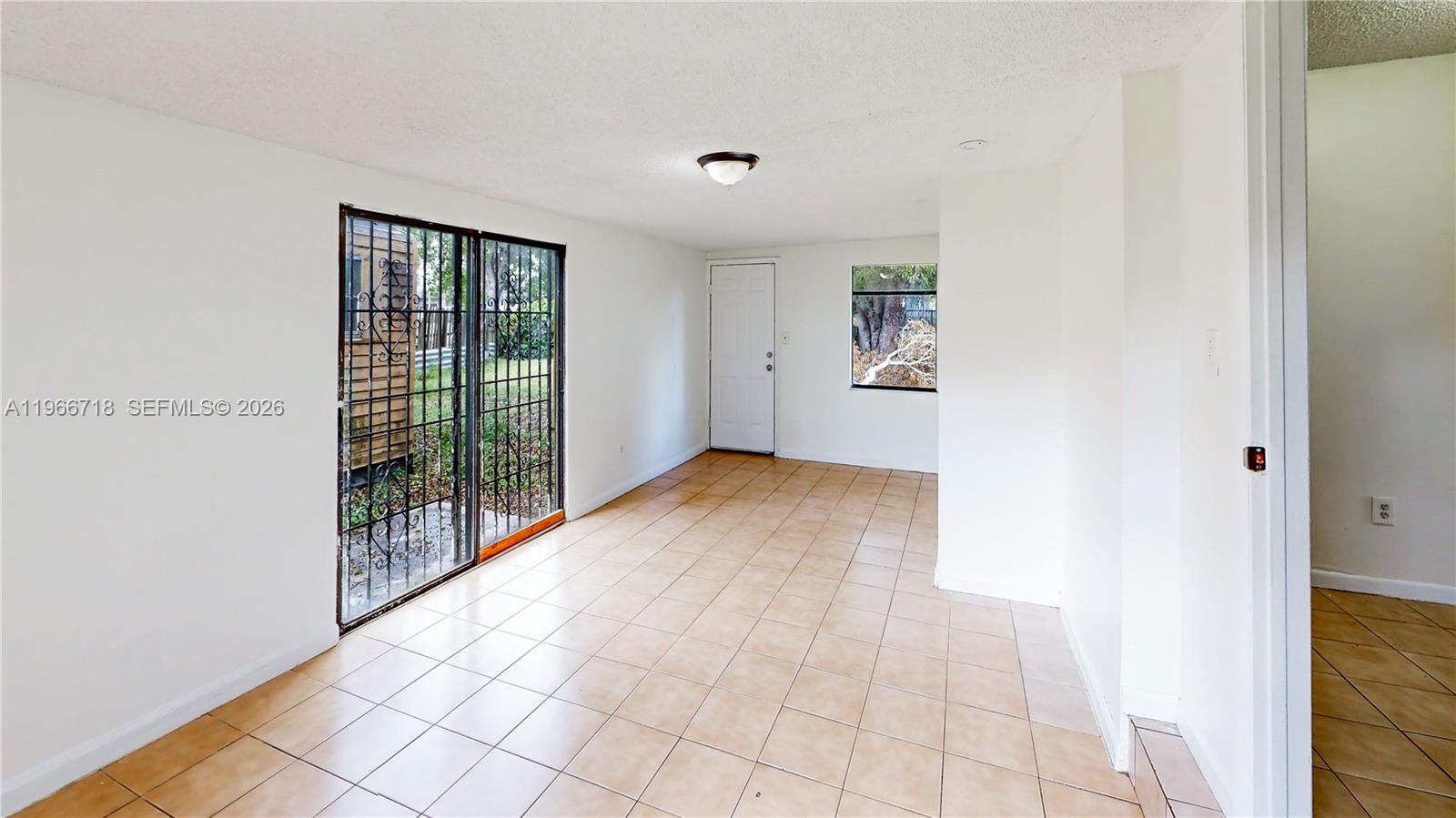 1664 Southwest 2 Court Homestead, FL 33030 - Photo 10 of 57 a view of an empty room with glass door