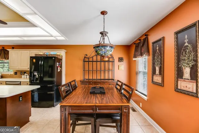 a dining room with a table and chairs