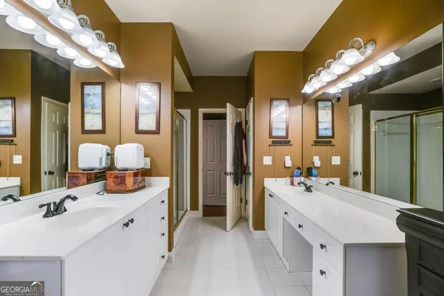 a spacious bathroom with a double vanity sink mirror and double
