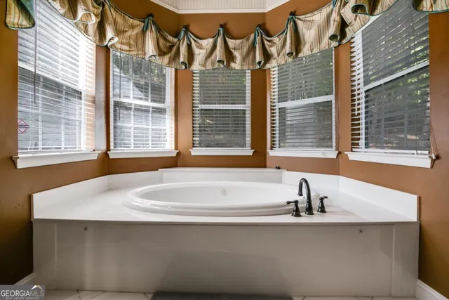 a bathroom with a bathtub and next to a window
