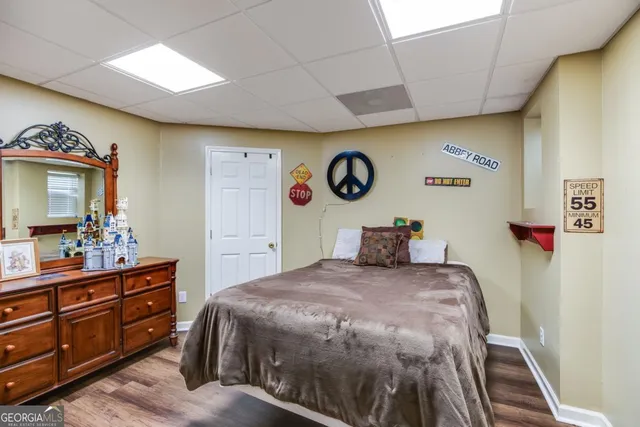 a bedroom with a bed and a dresser in it