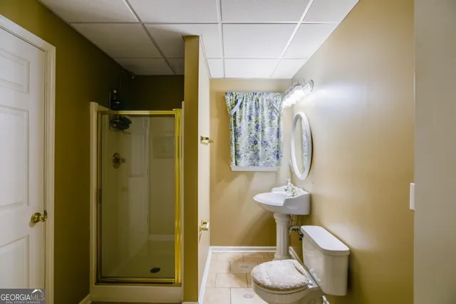 a bathroom with a shower and a sink
