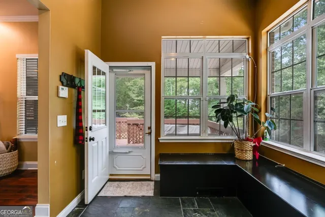 a room with pool table and windows