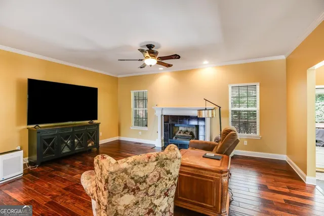 a living room with furniture a flat screen tv and a fireplace