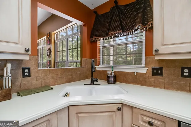 a kitchen with a sink and large window