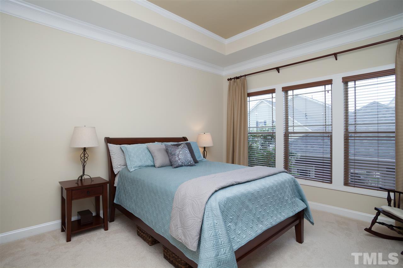 1410 Van Page Boulevard Raleigh, NC 27607 - Photo 13 of 25 a bedroom with a bed lamp and a large window
