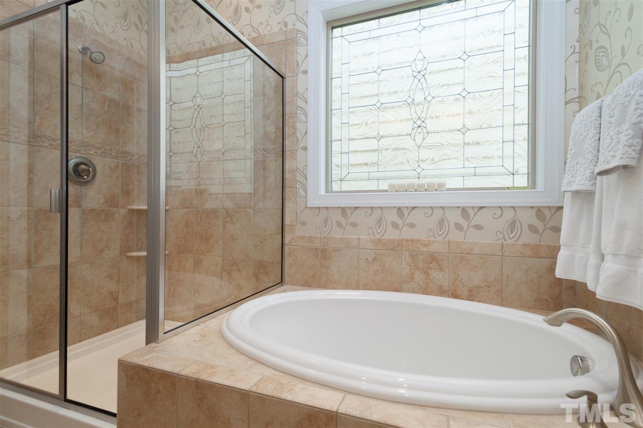 1410 Van Page Boulevard Raleigh, NC 27607 - Photo 15 of 25 a white bath tub sitting next to a shower