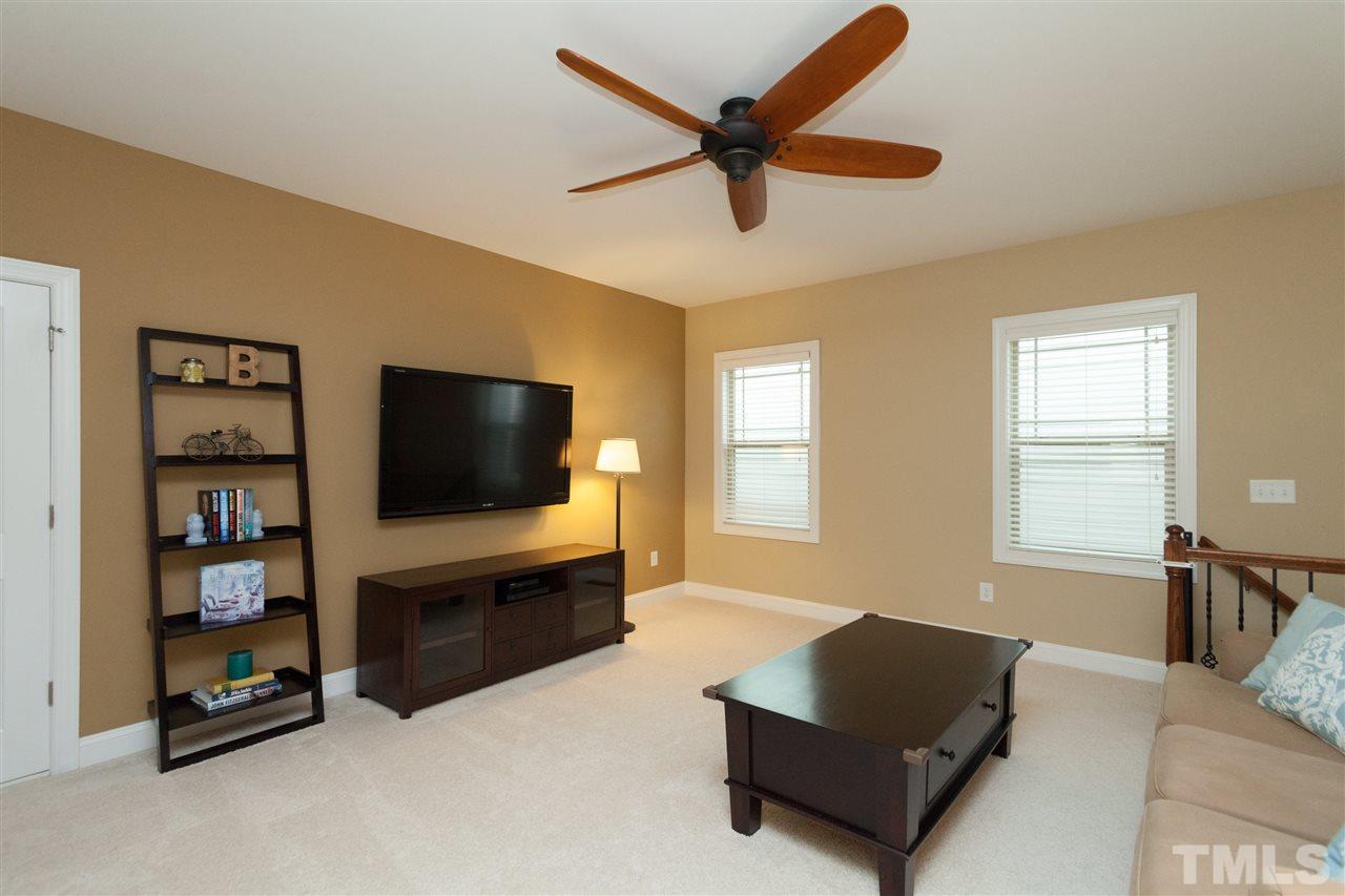 1410 Van Page Boulevard Raleigh, NC 27607 - Photo 16 of 25 a living room with furniture and a flat screen tv