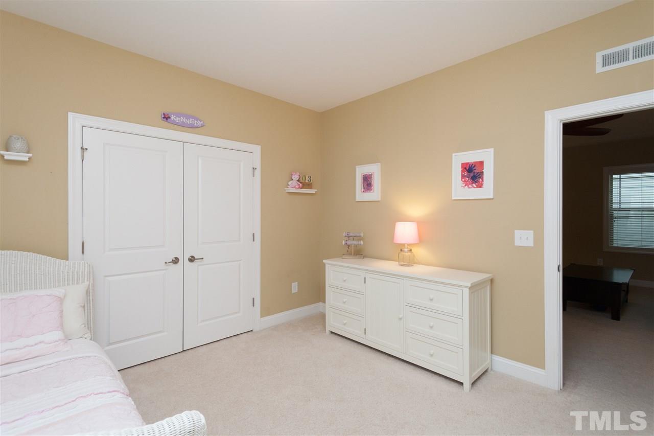 1410 Van Page Boulevard Raleigh, NC 27607 - Photo 18 of 25 a spacious bedroom with a bed and a view of bathroom