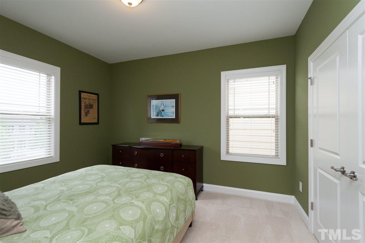 1410 Van Page Boulevard Raleigh, NC 27607 - Photo 21 of 25 a bedroom with a bed and a window