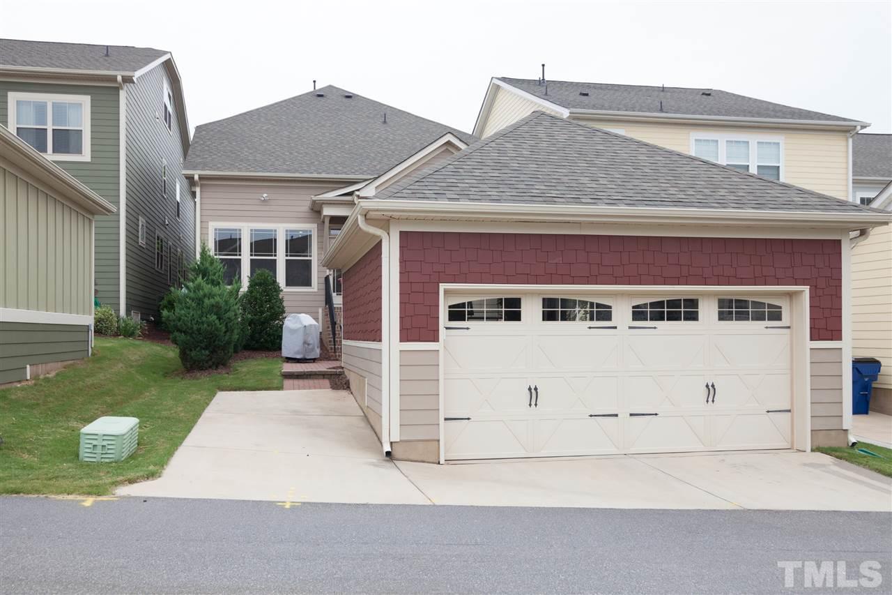 1410 Van Page Boulevard Raleigh, NC 27607 - Photo 23 of 25 a front view of a house with a yard and garage