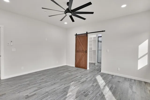 a view of walk in closet with empty racks