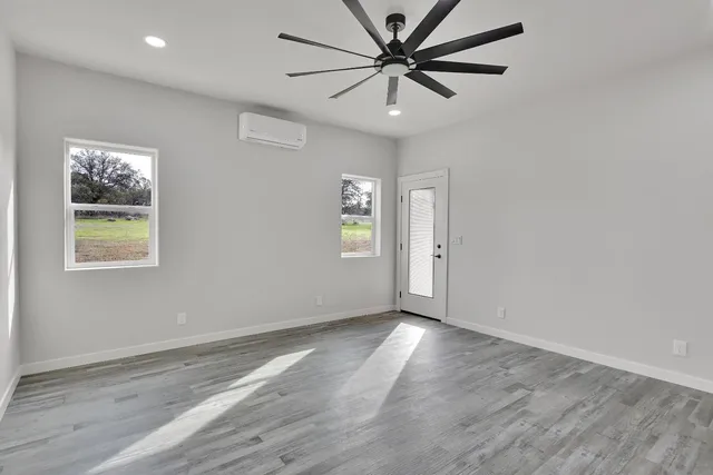 a view of a small space with wooden floor fan and window