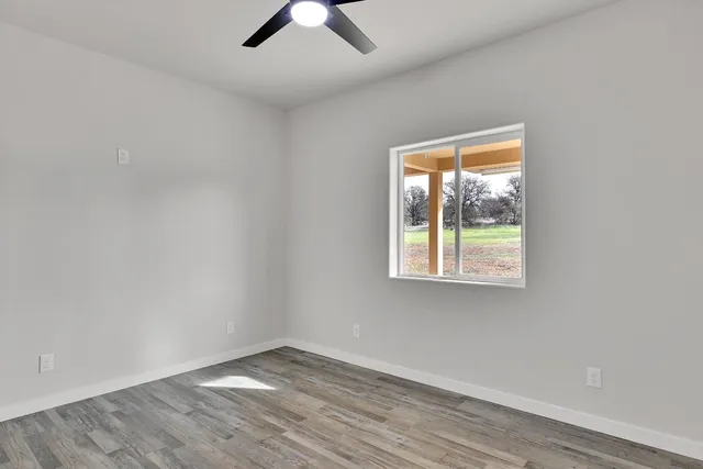 a bathroom with a granite countertop toilet and sink