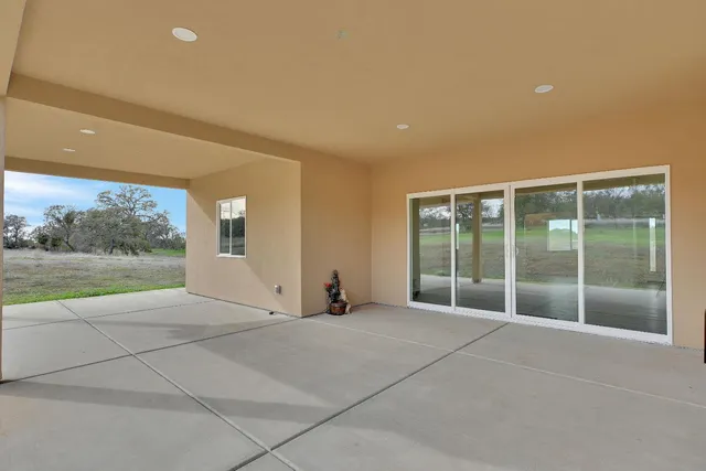 an empty room with projector and fan