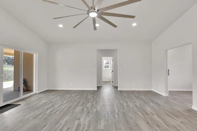 an empty room with wooden floor and door