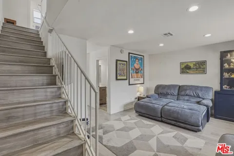 a living room with furniture and a painting