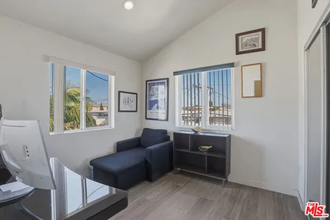 a view of a livingroom with workspace and a couch