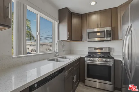 a kitchen with a sink stove and microwave