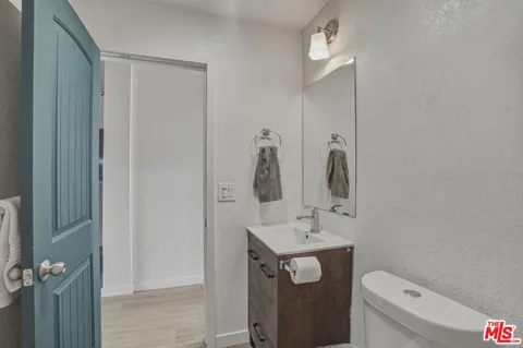 a bathroom with a toilet sink and mirror