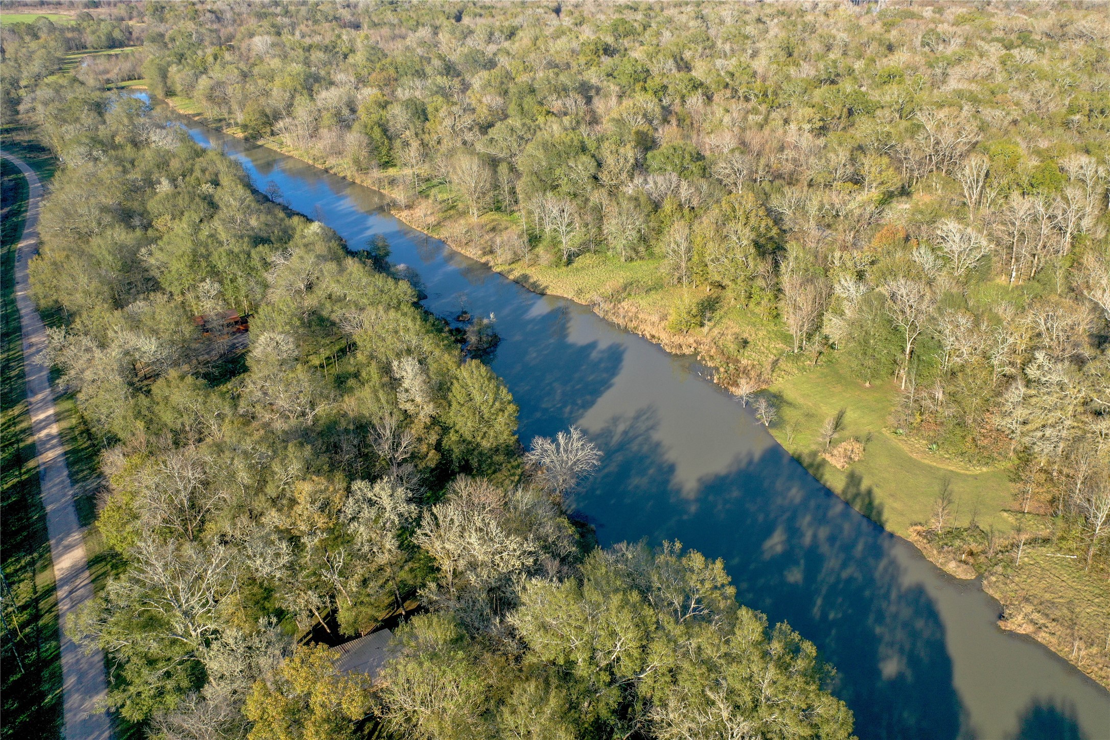 212 Carpenter Drive Cleveland, TX 77327 - Photo 10 of 23 a view of a lake in a forest