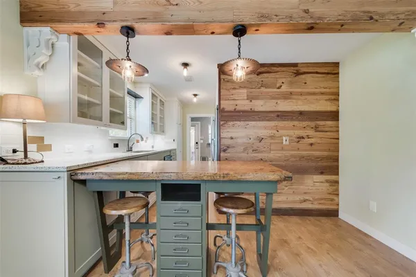 a view of a kitchen with a table and a chair