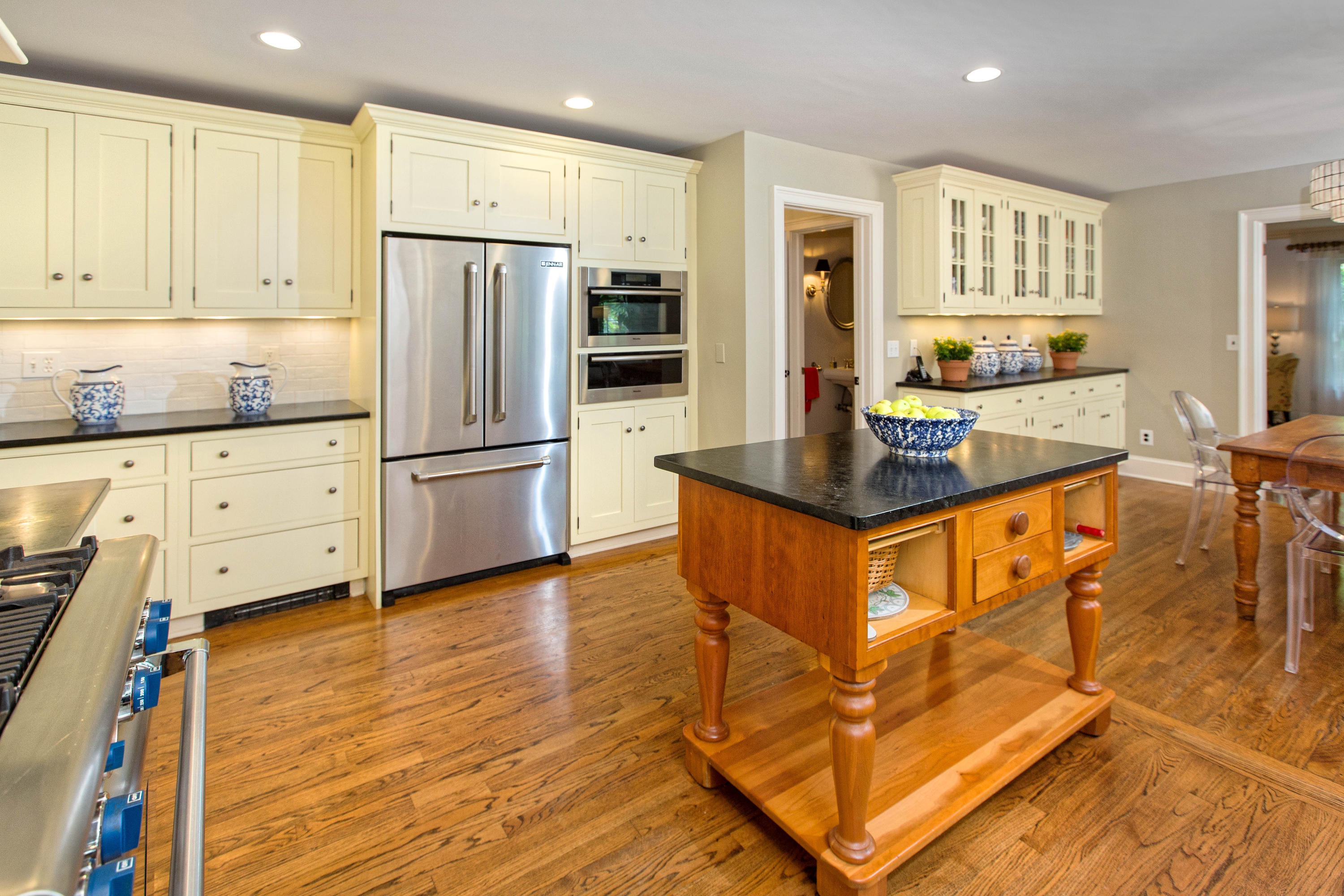 292 Briscoe Road New Canaan, CT 06840 - Photo 11 of 45 a kitchen with stainless steel appliances granite countertop a refrigerator a stove a sink and white cabinets with wooden floor