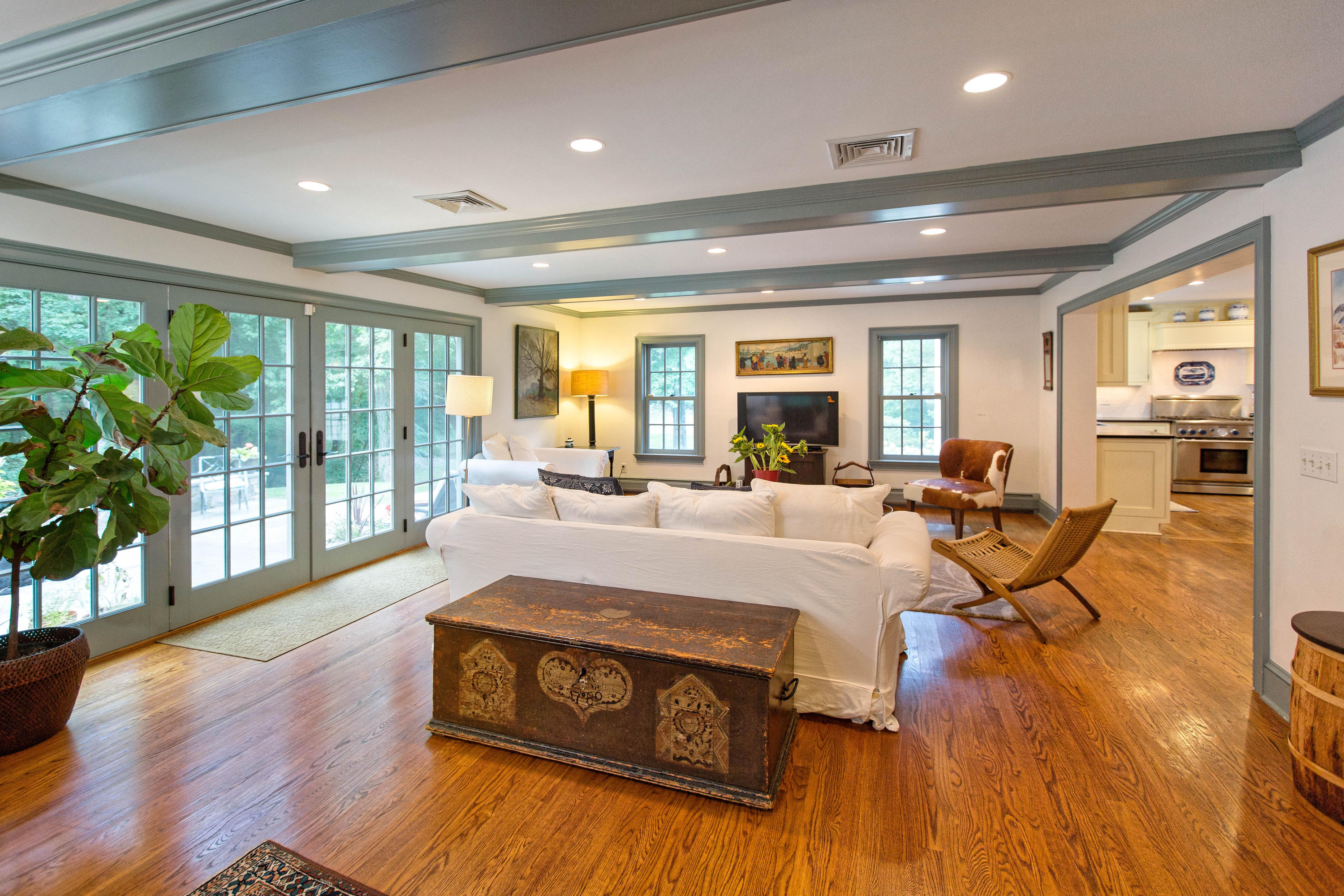 292 Briscoe Road New Canaan, CT 06840 - Photo 15 of 45 a living room with furniture large windows and wooden floor