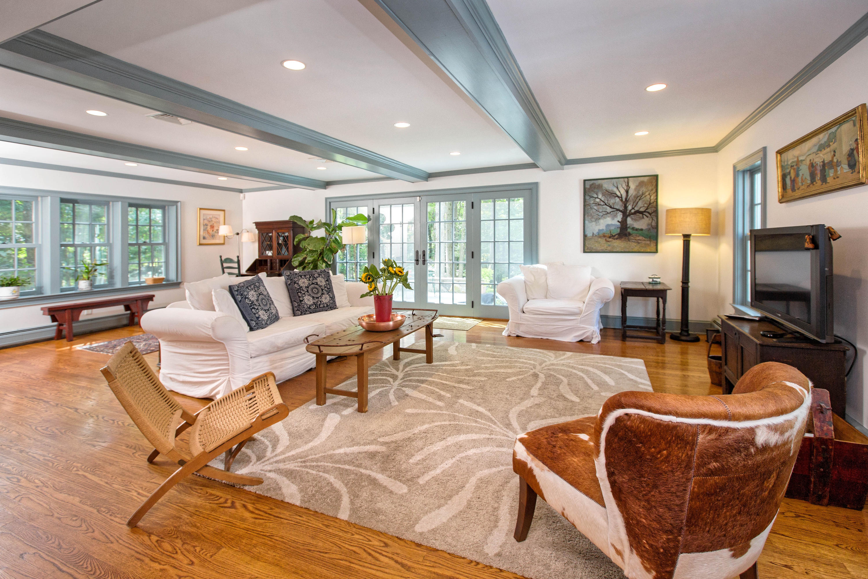 292 Briscoe Road New Canaan, CT 06840 - Photo 16 of 45 a living room with furniture a flat screen tv and a large window