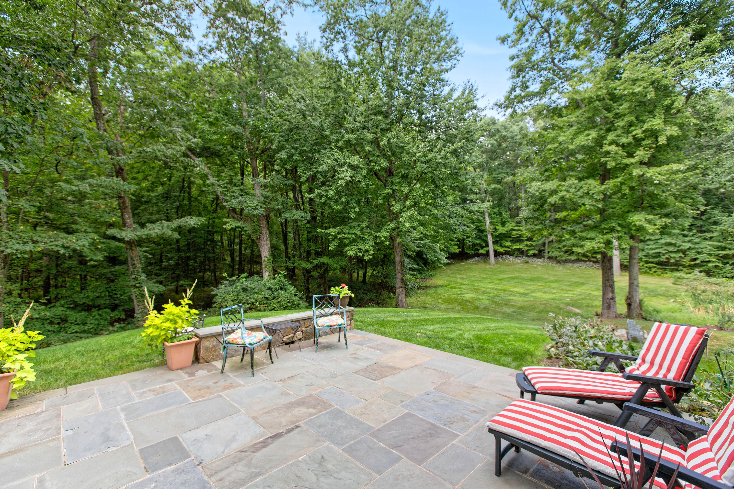 292 Briscoe Road New Canaan, CT 06840 - Photo 45 of 45 a view of a sitting area with chairs and garden