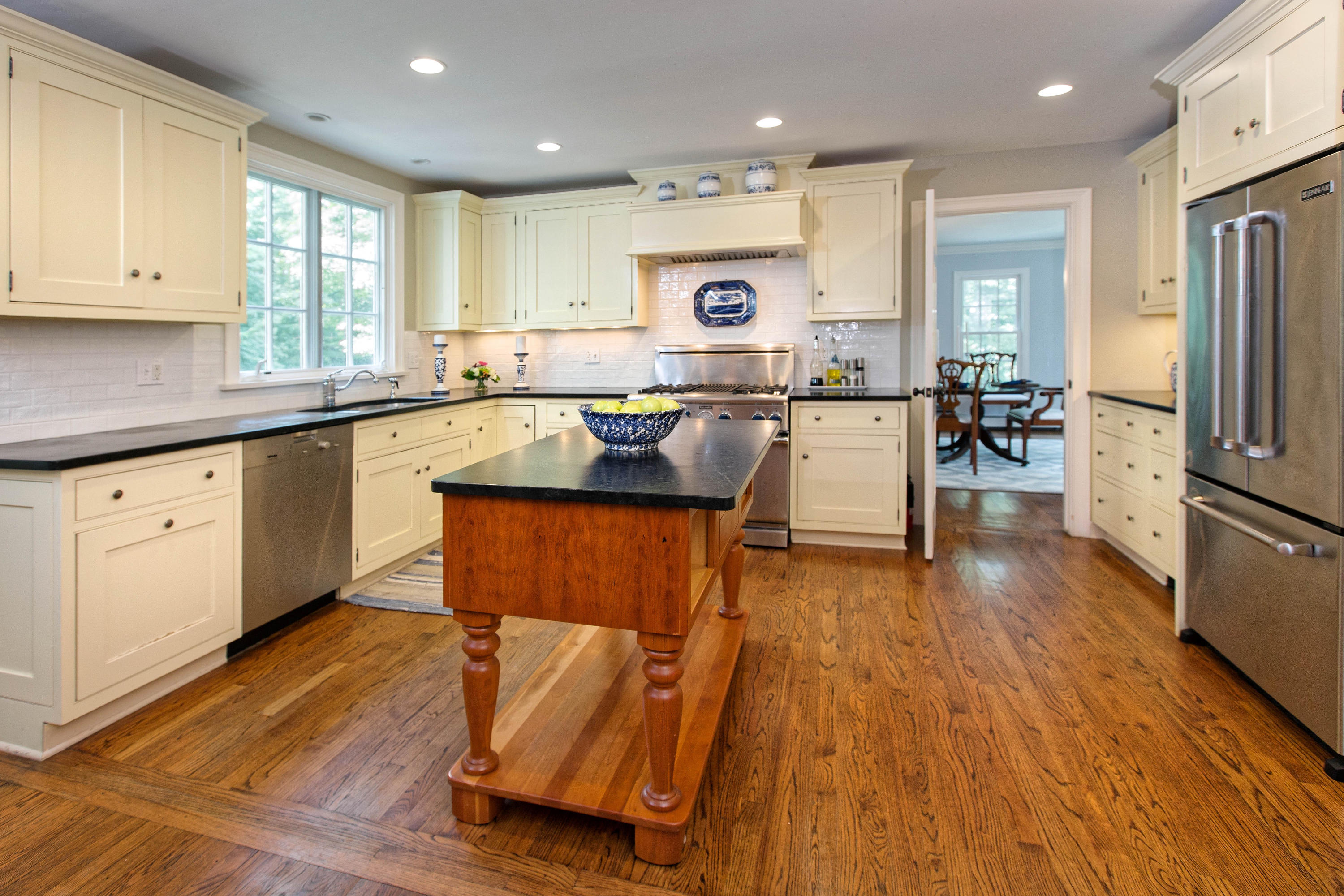 292 Briscoe Road New Canaan, CT 06840 - Photo 8 of 45 a kitchen with stainless steel appliances granite countertop wooden floors stove top oven and refrigerator