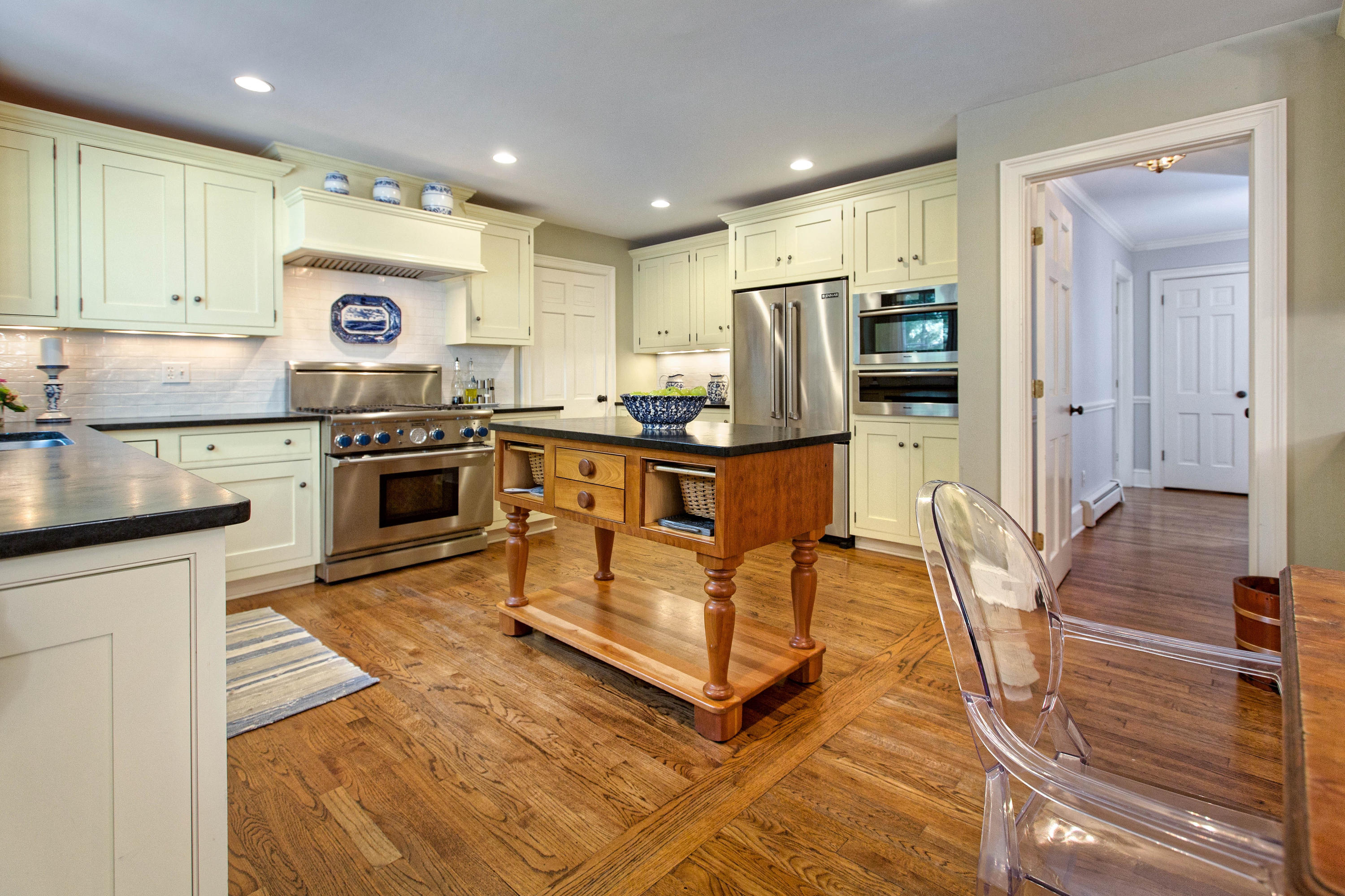 292 Briscoe Road New Canaan, CT 06840 - Photo 9 of 45 a kitchen with stainless steel appliances granite countertop a stove top oven a sink island and chairs