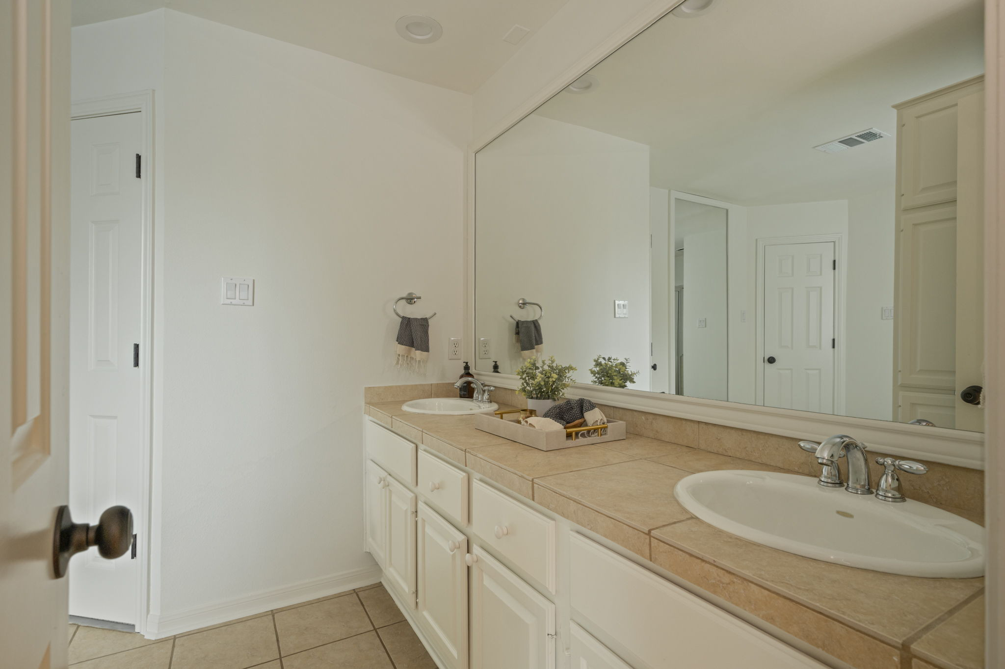 6010 Long Champ Court, Unit 113 Austin, TX 78746 - Photo 21 of 25 Full bathroom featuring light tile patterned floors and double vanity