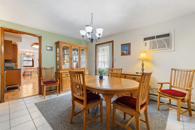 a view of a dining room with furniture and a chandelier