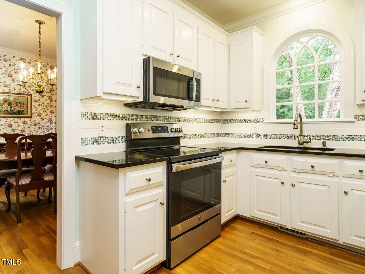 7201 Jonathan Drive Wendell, NC 27591 - Photo 13 of 43 a kitchen with stainless steel appliances granite countertop a stove a sink and a microwave