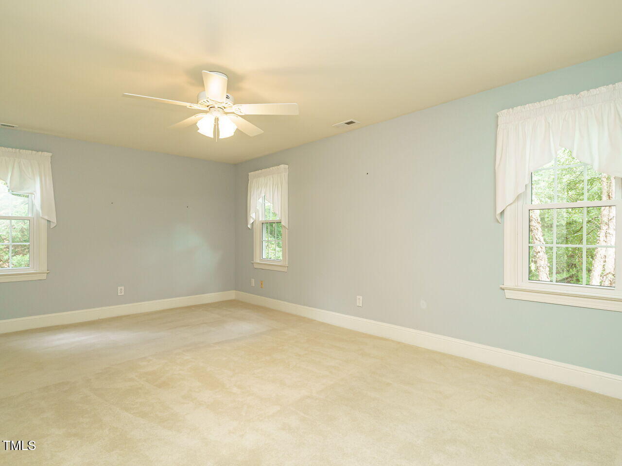 7201 Jonathan Drive Wendell, NC 27591 - Photo 20 of 43 an empty room with windows and fan