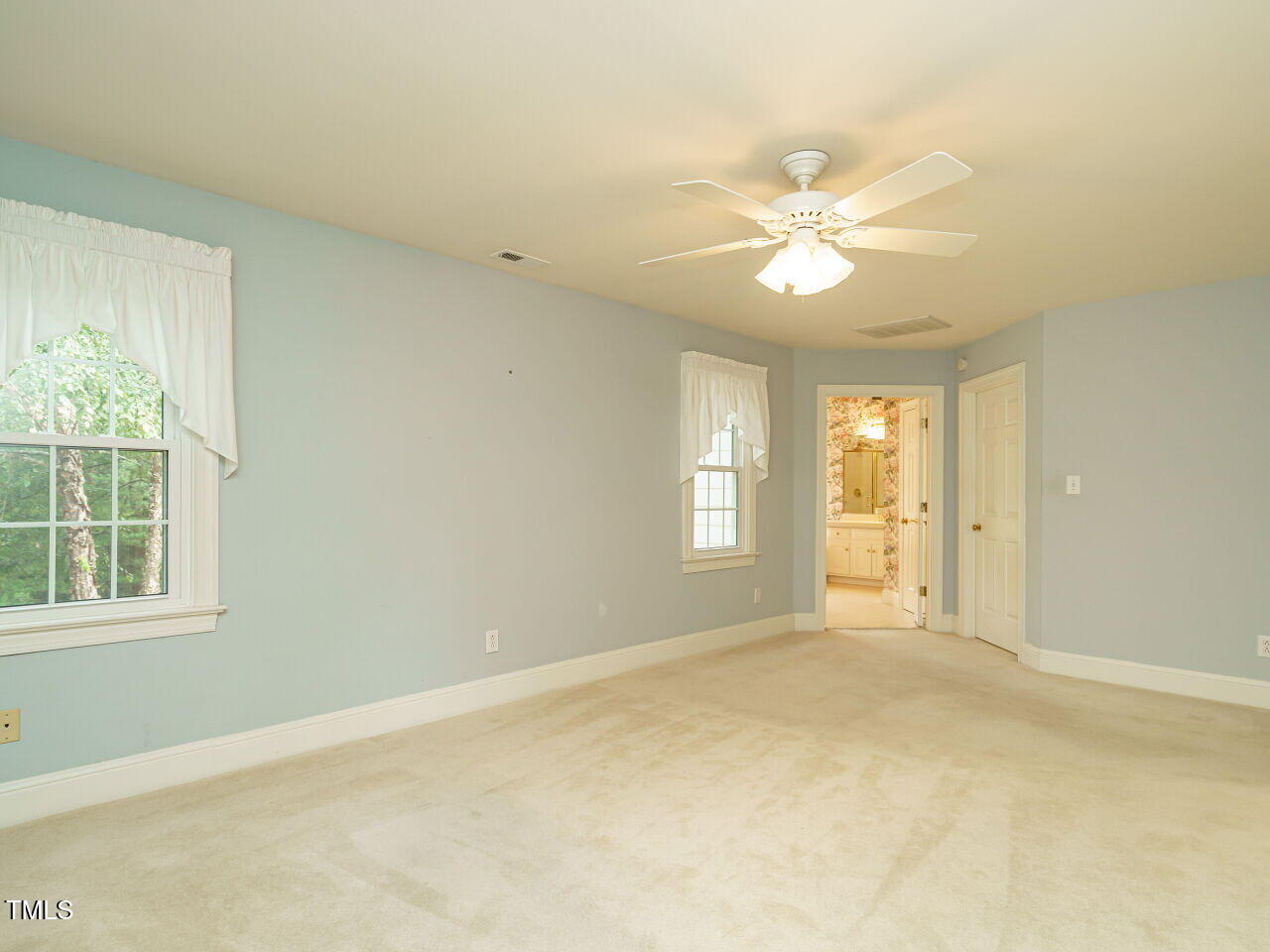 7201 Jonathan Drive Wendell, NC 27591 - Photo 21 of 43 an empty room with windows and fan