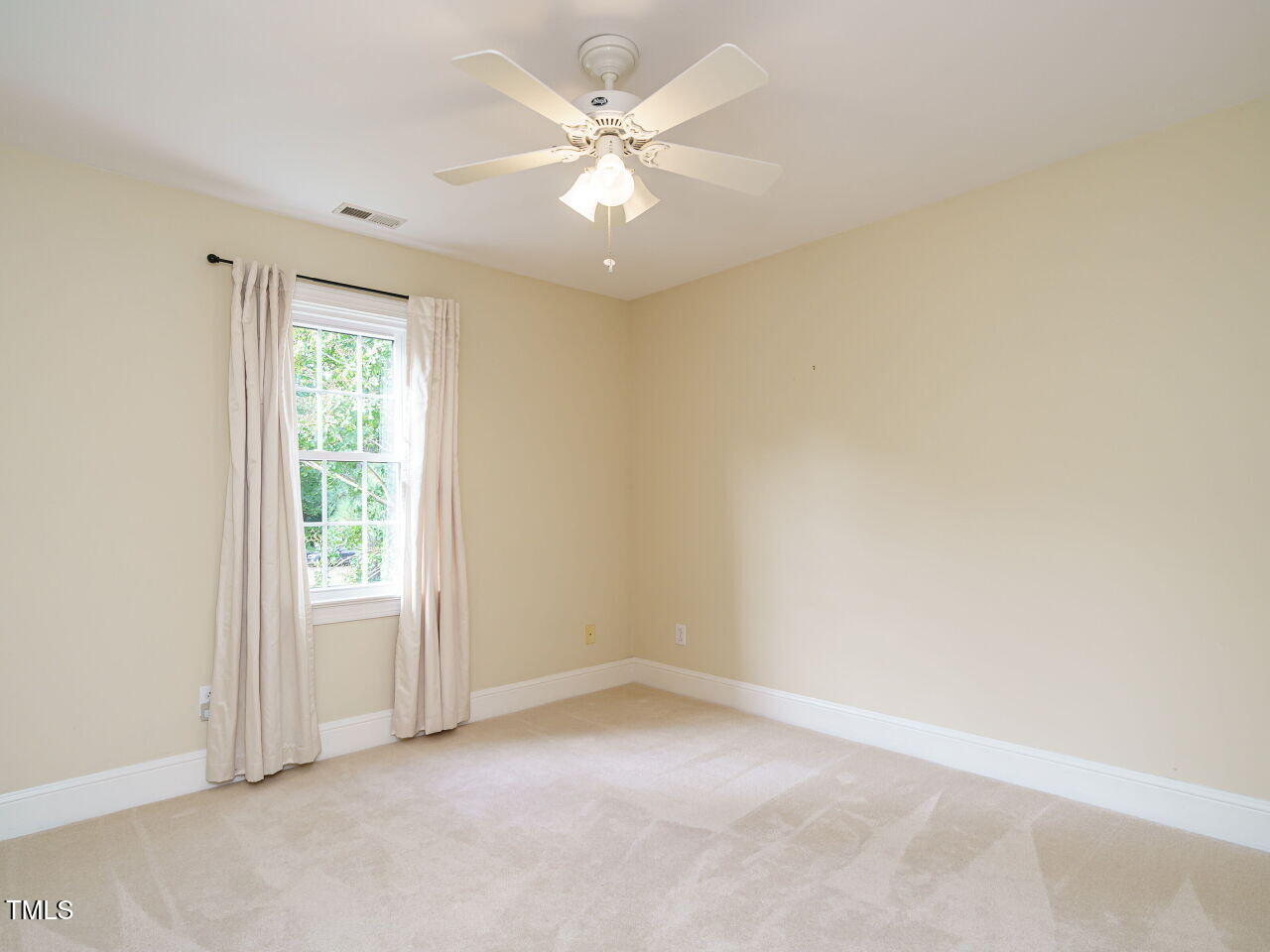 7201 Jonathan Drive Wendell, NC 27591 - Photo 26 of 43 an empty room with windows and ceiling fan