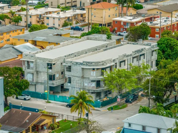 a aerial view of multiple houses with yard