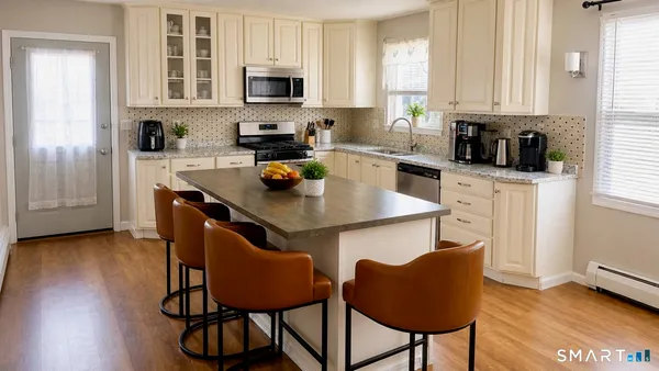 a kitchen with stainless steel appliances a stove a sink cabinets and a dining table