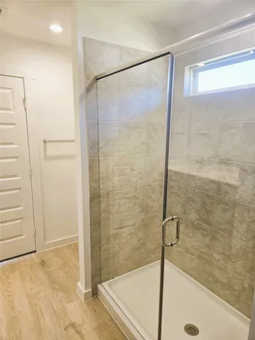 a bathroom with a glass shower door