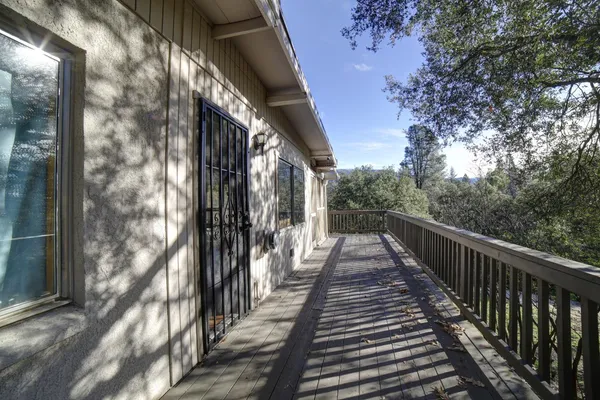 a view of balcony with lots of trees