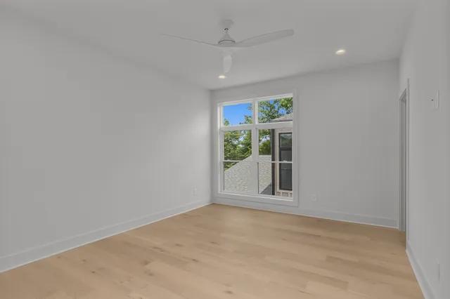an empty room with windows and closet