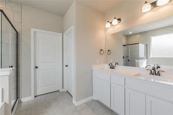 a bathroom with a double vanity sink and mirror