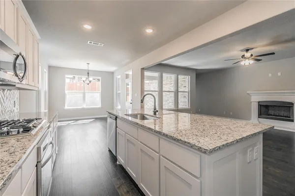 a kitchen with sink and stove