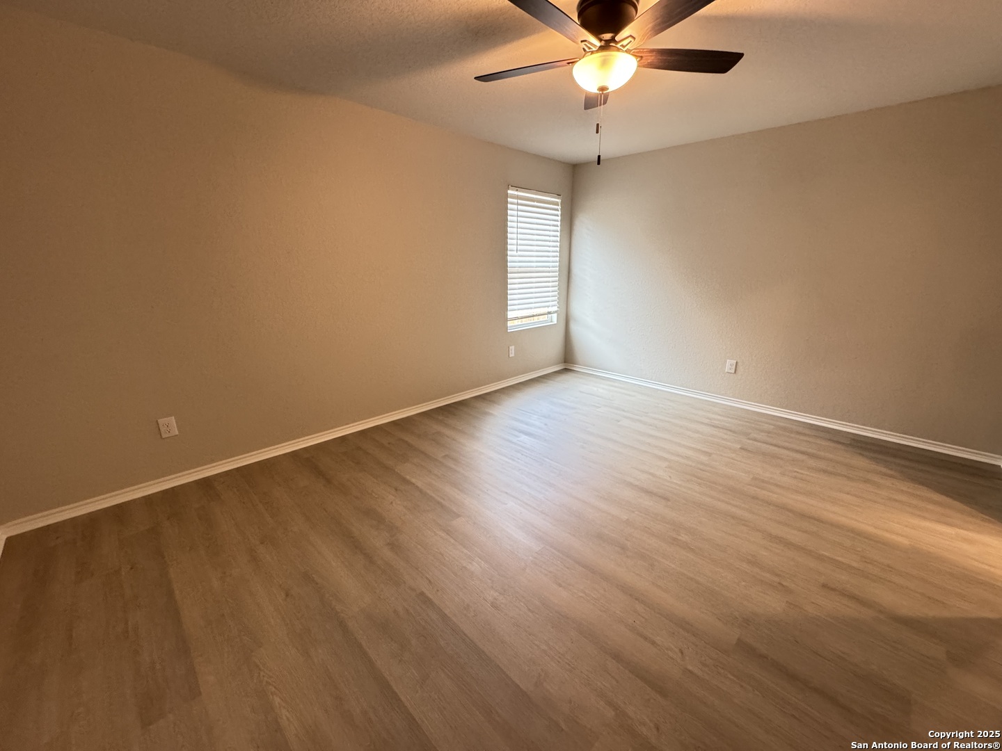 5523 Basil Chase St. Hedwig, TX 78152 - Photo 6 of 15 an empty room with wooden floor and windows