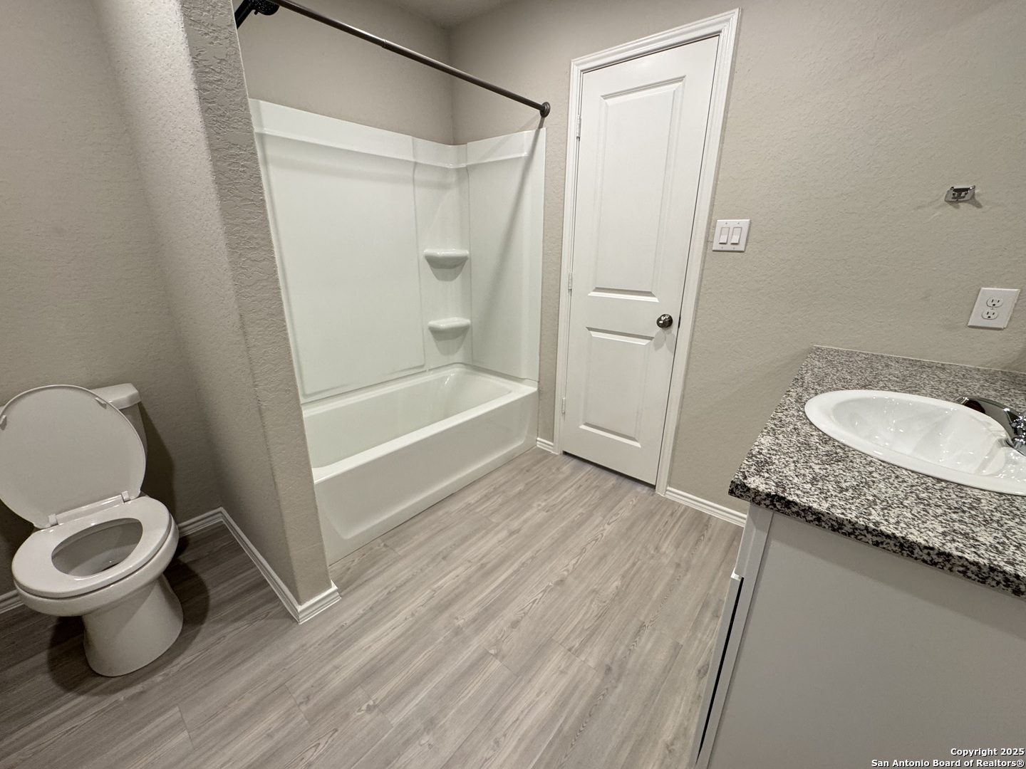 5523 Basil Chase St. Hedwig, TX 78152 - Photo 7 of 15 a bathroom with a granite countertop sink toilet and shower