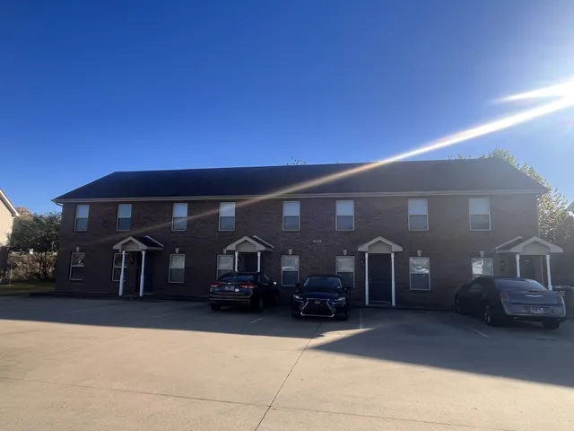 a view of a car park in front of house