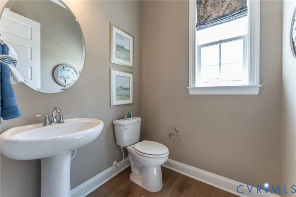 a bathroom with a toilet a sink and a mirror
